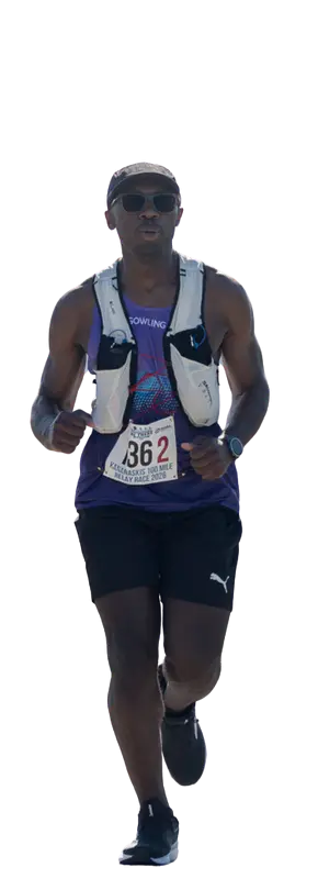 A person wearing sunglasses, a headband, running vest, and race bib number 362 is running. They are dressed in a purple tank top, black shorts, and black running shoes. The background is plain white.